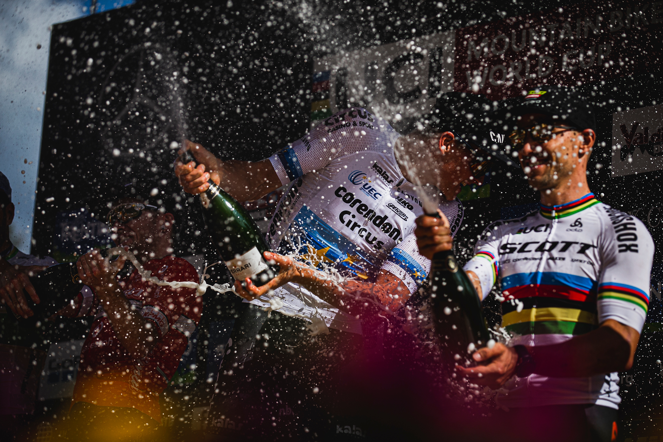 Van der Poel and Schurter spray champagne on the podium.